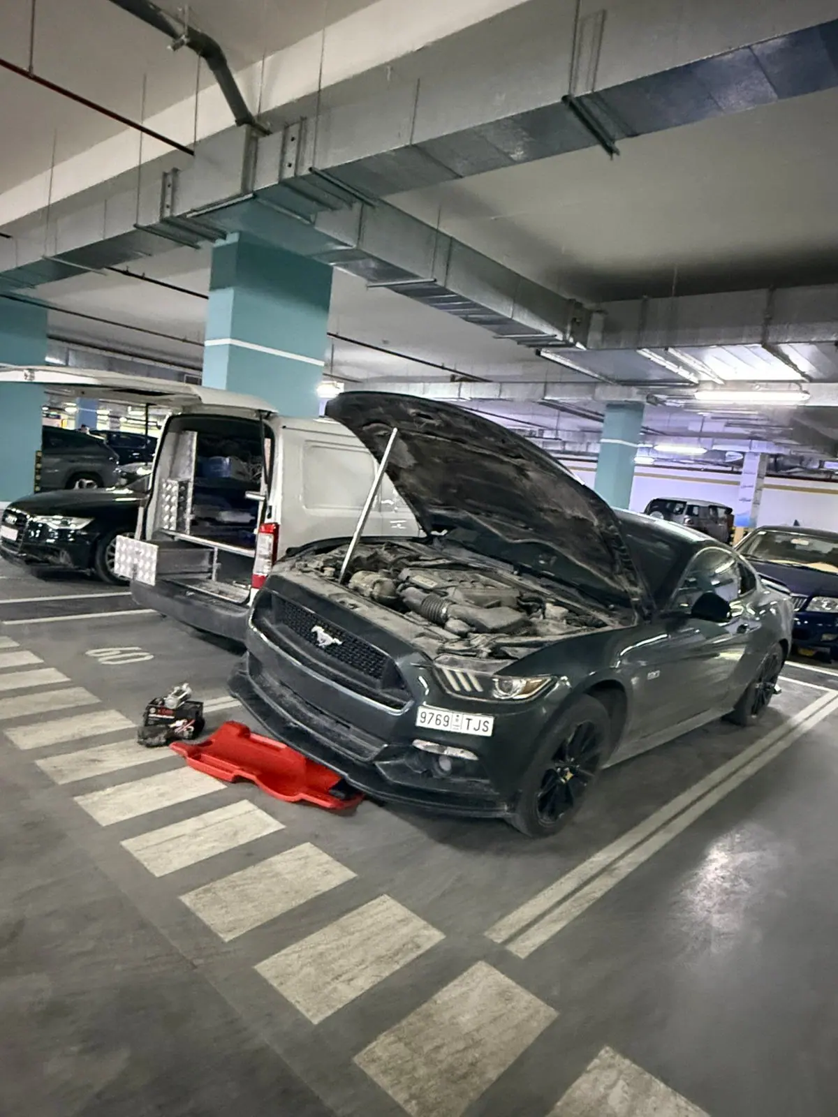 Mobile service on a Ford Mustang GT in the underground car park of a Riyadh tower